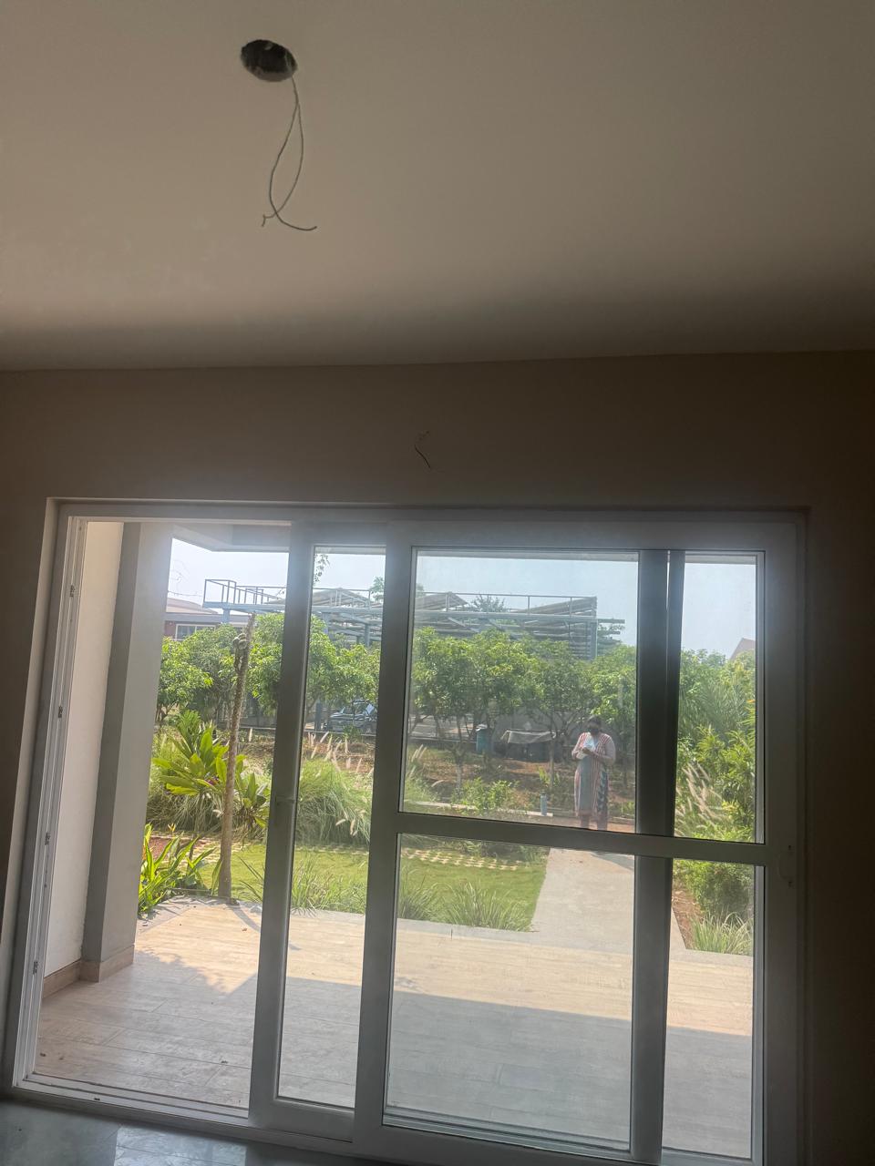 Ceiling with an exposed electrical drop before the light fitting is installed