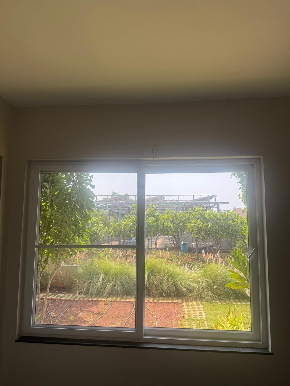 Large window opening toward the planted garden