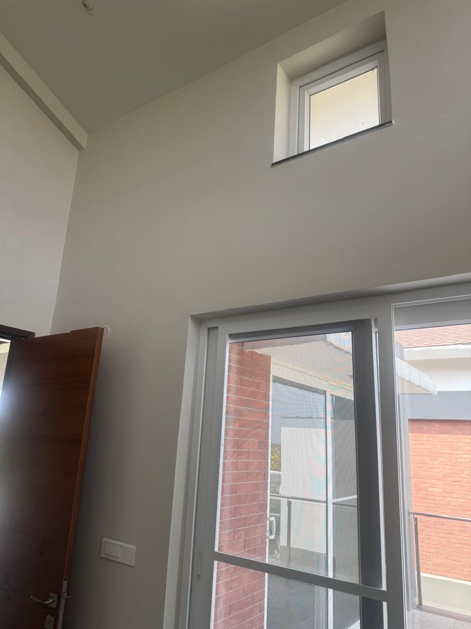 Unfinished villa wall with installed switch plate and electrical point